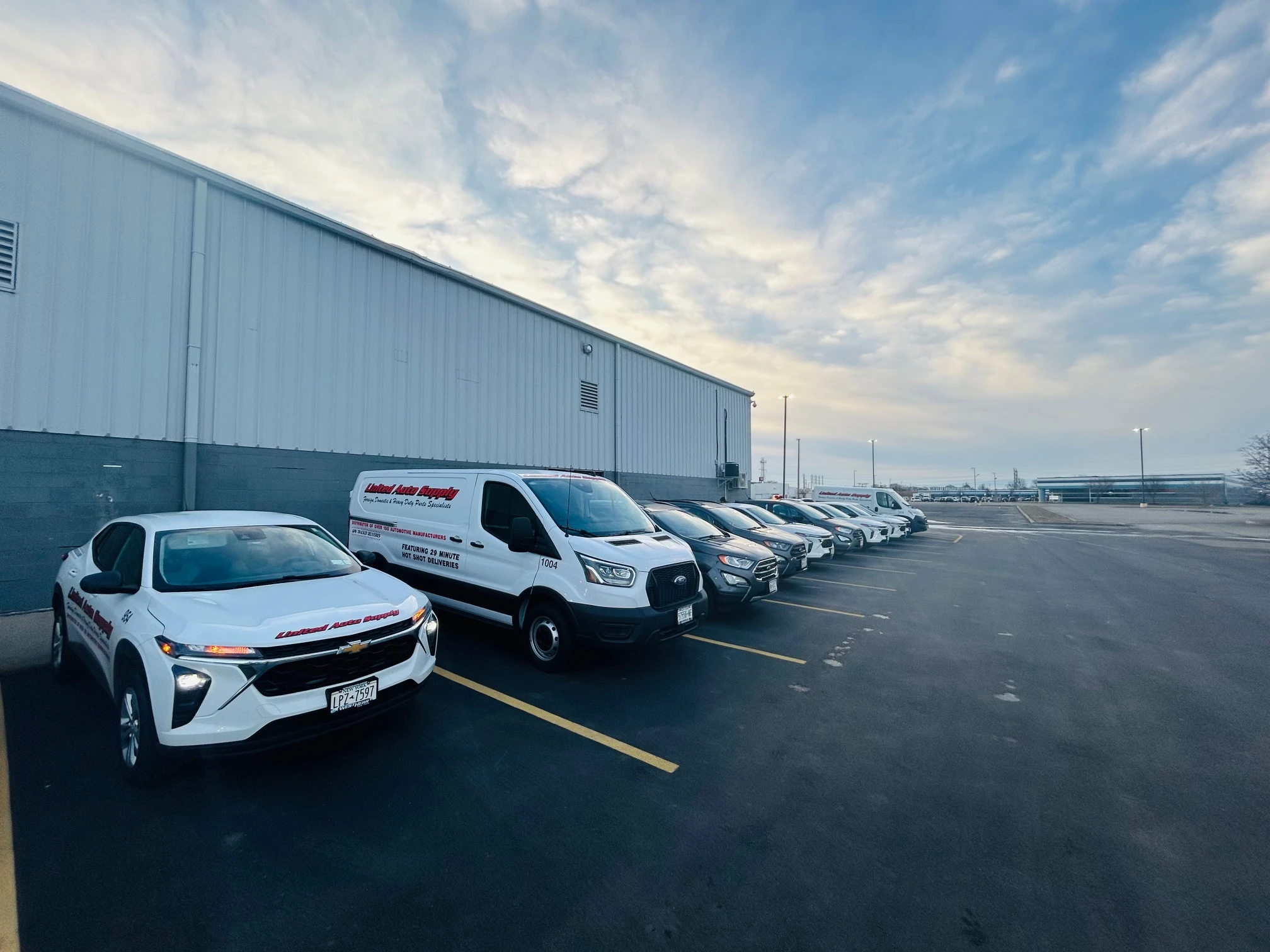 Delivery vans parked outside the United Auto Supply Distribution Center in Tonawanda, New York.