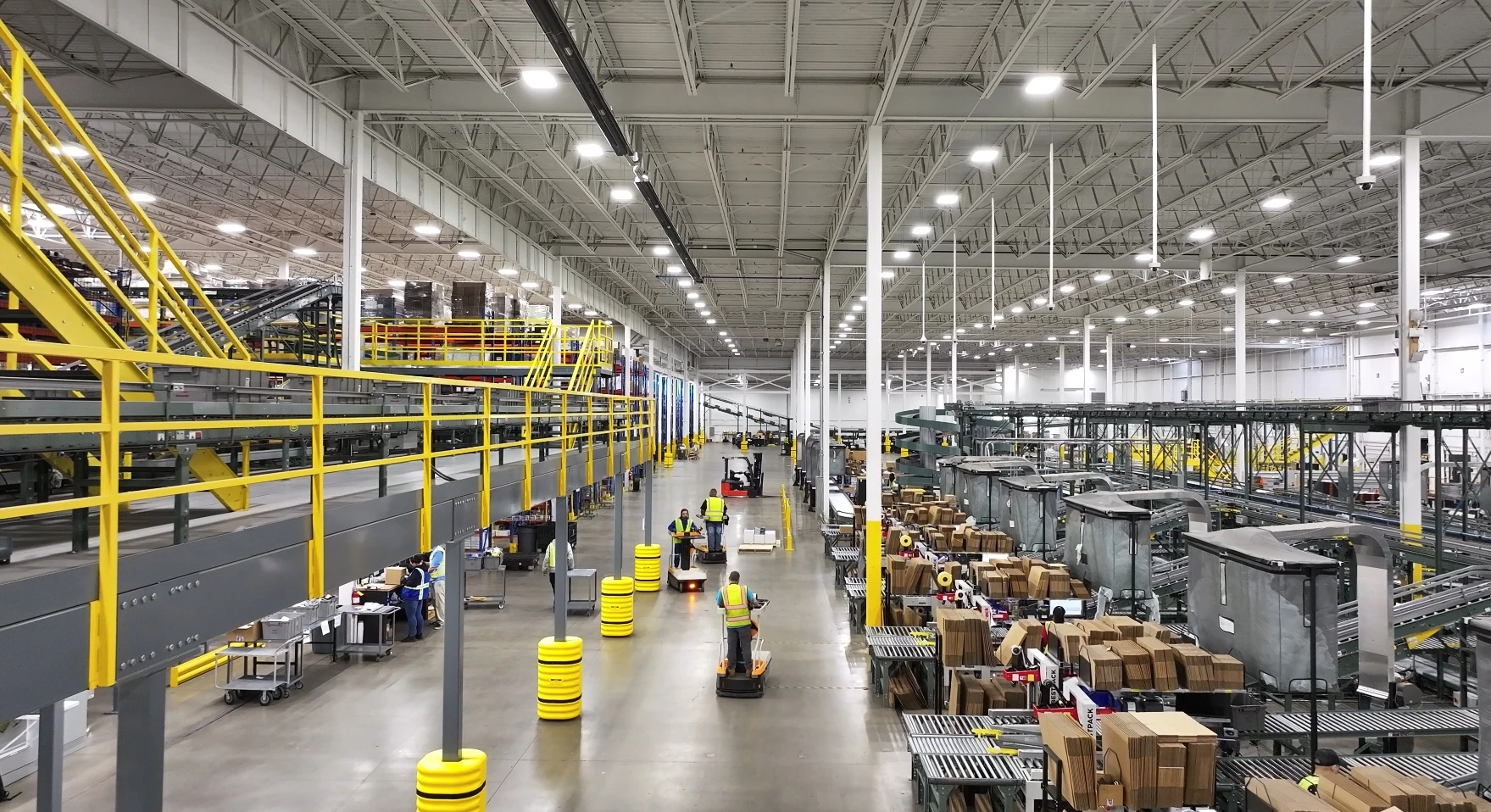 Mechanical conveyer belts moving parts, a walkway for machinery to move through and packing stations where auto parts are packed and shipped.